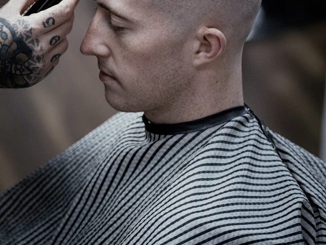 A straight razor sharpening the hairline on a fresh line-up.