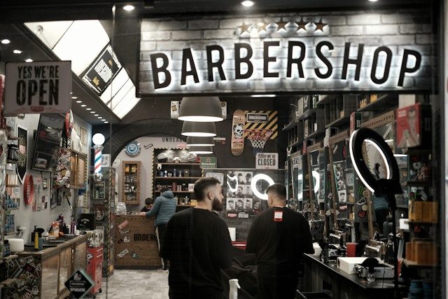 The shopfront on Fourth Avenue with the window sign lit.